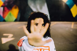 Woman holding out her hand as a stop signal