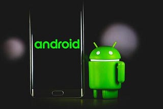 Smartphone can be seen on the left with the word ‘android’ overlaid on top. The green android mascot figurine can be seen to the right.