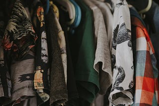 Cluttered Closet with Clothes falling off hangers