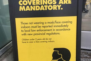 A “Masks/face coverings are mandatory,” sign at a local No Frills supermarket in Pickering, Ontario