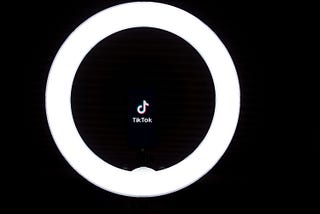 TikTok logo with a ring light around it