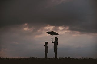 Two people sharing one umbrella