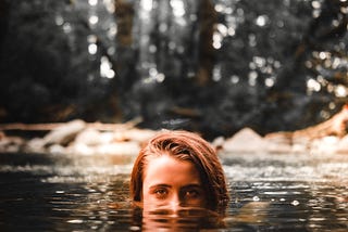 Person swimming in a creek