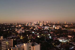 Sunset over the rooftops of Asuncion with a view of the skyline