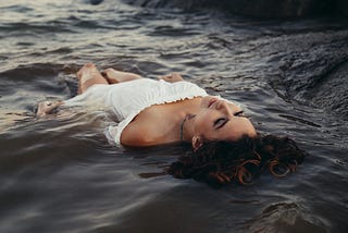 Woman in white dress in water