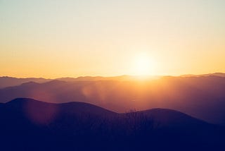 hills highlighted by the sun rising behind them