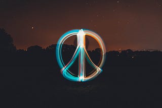 A peace sign glowing in the dark.