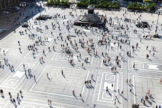 A European city square full of people, creating patterns of flows and interactions