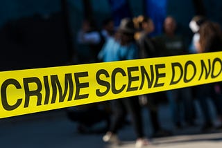 crime scene yellow tape stretched across a street