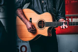 person strumming a classical guitar