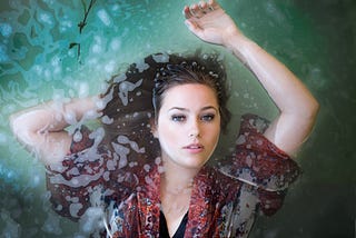 A pretty woman floating in water with enigmatic look…enjoying herself or about to end her life