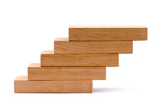 wooden blocks one on top of the others, forming a ladder