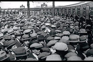 Group of men outside a soccer game wearing hats