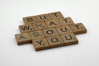 image with wood background saying “But What About You”