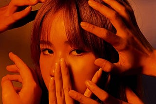 sad asian female touched with hands of people