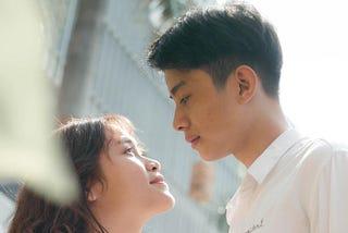 man in white dress shirt looking at a woman in white dress