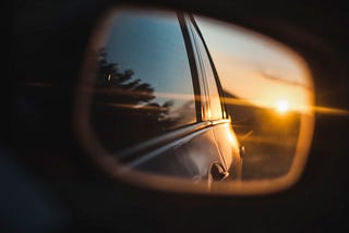 Reflection in side mirror  of sun setting behind the car