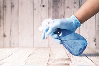 Spray bottle being used for cleaning representing cleaning strategies for those with inattentive ADHD