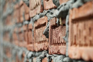 Bricks and mortar form a strong wall.