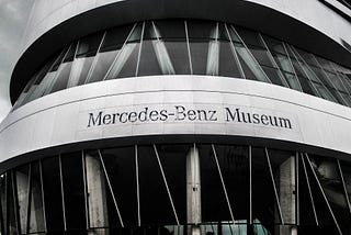 Black and white pic of the front of a Mercedes-Benz Museum.