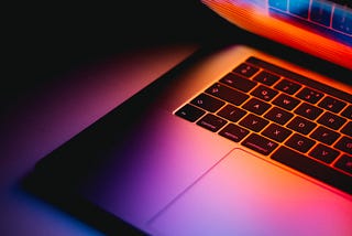 A laptop screen illuminates its keyboard