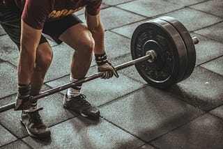 Man bending down to do a deadlift.