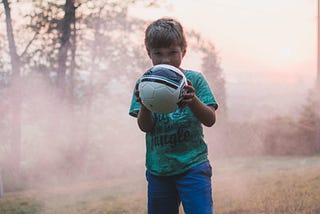 Little boy holding a soccer ball