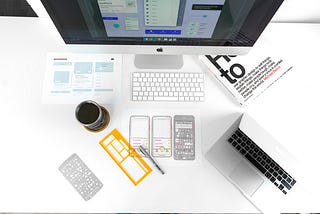 Picture showing paper wireframes and a computer