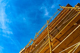 A photo of a building being erected against a deep blue sky.