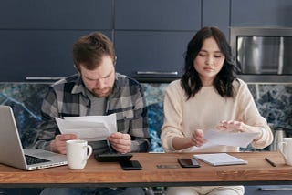 A couple working on their bills.