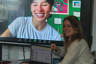 Photo of Carla Mullet Lopez with Diane Guerrero on the big screen in her classroom