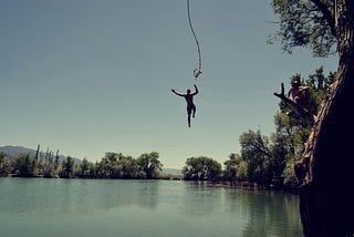 a person jumping into a lake