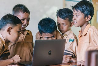 Children at school watching laptop