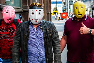 Three fake men with masks on.