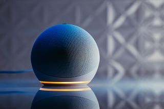 Photo of Amazon’s Echo product on a table with a shadowy background