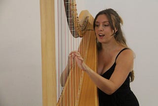 Angelina Egerton playing the harp at Manchester Jazz Festival