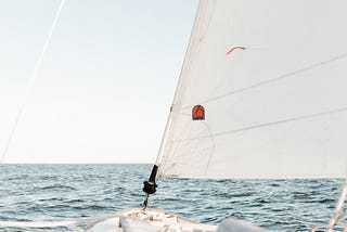 The bow of a boat from the perspective of someone in the middle of a sailing adventure.