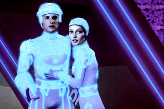 Tron and Yori embrace in the digital world of 1982’s Tron.