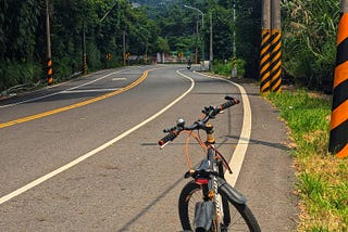 My bike on the road. A mountain in the distance.