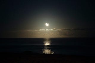 Waning moon over water