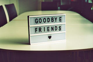 Picture of a GOODBYE FRIENDS sign on a table