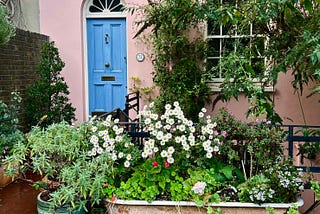 Photo of a vintage bathtub outside, filled with flowers