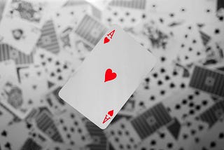 Ace of hearts against a background of blurry cards