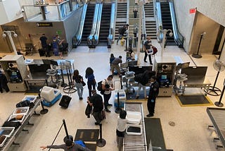Passengers pass through TSA at JFK airport.