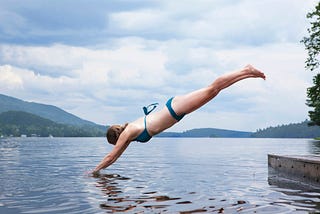 A person diving into a lake head first