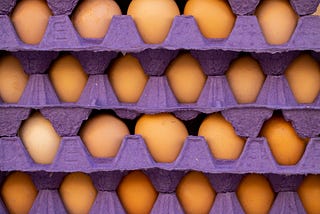 A stack of eggs in cardboard trays