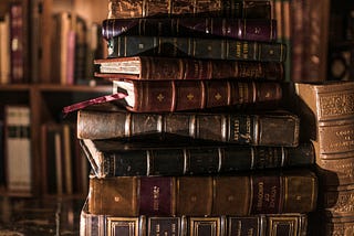 Stack of old, leather-bound books.