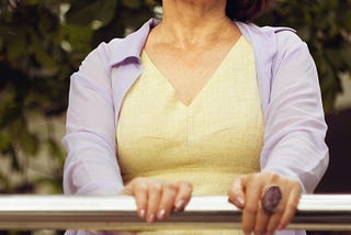woman standing holding onto a rail