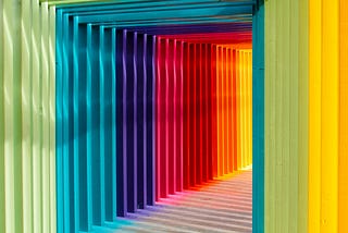 A beautiful rainbow lit hallway leading into a place of light