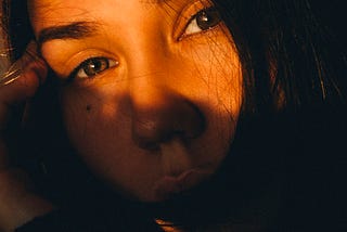 A close-up of a woman talking on a cell phone.